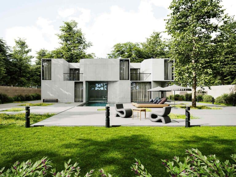 Modern two-story concrete house with large windows, outdoor seating area, and green lawn surrounded by trees and shrubs on a sunny day.